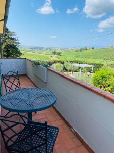 a table and chairs on a balcony with a view of a field at La Casina di Nonno Enzo in Vinci