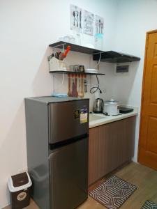 a kitchen with a stainless steel refrigerator and a counter at Fully Furnished Staycation - Neflix, Pool,Can cook near Mactan Airport in Maribago