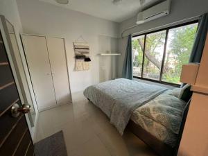 A bed or beds in a room at Pali Carters Building 102, 20th Road, Khar West by Connekt Homes