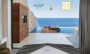 a room with a plunge pool and a view of the ocean at Emerald Villas & Suites - The Finest Hotels Of The World in Agios Nikolaos