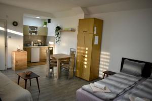 a living room with a couch and a table and a kitchen at Petković apartman in Bajina Bašta