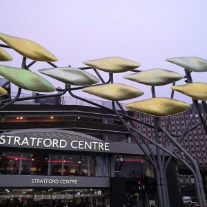 a metal sculpture in front of a shopping center at Cosy apartment in London