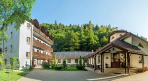 a group of buildings with trees in the background at Pensiunea Sibiel in Sibiel