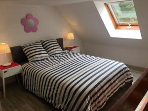 1 dormitorio con 1 cama con 2 mesas y 2 lámparas en Studio duplex vue mer 100m de la plage, en Saint-Nic