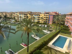 arial view of a marina with boats and palm trees at Sotogrande Marina Beach in Sotogrande