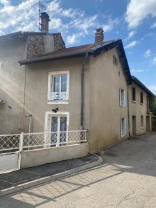 a house with a balcony on the side of it at Gîte à la campagne in Beaux