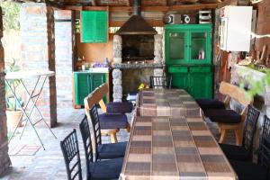 a long table in a kitchen with green cabinets at Apartman Avala Beograd in Beli Potok