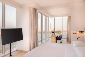 a hotel room with a bed and a tv at Four Points by Sheraton Jeddah Corniche in Jeddah