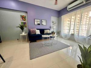 a living room with purple walls and a blue couch at Pali Carters Building 801, 20th Road, Khar West by Connekt Homes in Mumbai