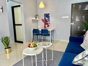 a living room with a blue couch and a table with fruit on it at Pali Carters Building 801, 20th Road, Khar West by Connekt Homes in Mumbai