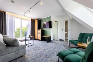 a living room with a couch and a table at Hotel Südblick in Norderney