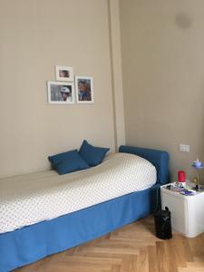 a bedroom with a blue and white bed and a table at Endless Summer in Viareggio