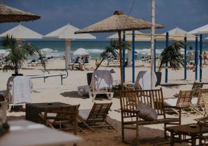 a group of chairs and umbrellas on a beach at Studio near the sea in Netanya
