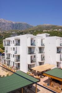 an aerial view of a building with mountains in the background at PATIO MARE in Dhërmi