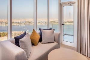 a living room with a couch and large windows at Four Points by Sheraton Jeddah Corniche in Jeddah