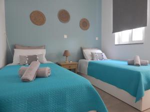 two beds sitting next to each other in a bedroom at Pervoli in Faliraki