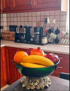 a bowl of fruit on a counter in a kitchen at Thira Apartment near Athens Airport in Spata