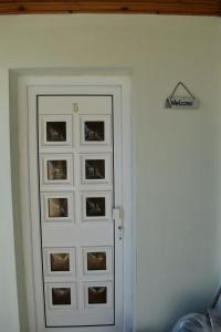 a white door with pictures on a wall at Studios Centro 5 - 2nd Floor in Potos