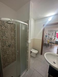 a bathroom with a shower and a toilet and a sink at Il Guernico appartamenti in Volterra +34 photos