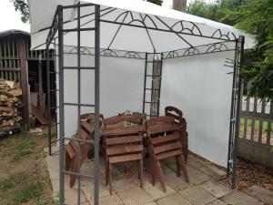a greenhouse with a wooden bench in front of it at Letniskowy Domek Berneński Zakątek in Charzykowy