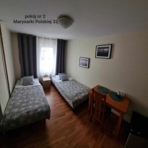 Postel nebo postele na pokoji v ubytování Syrenka Apartamenty