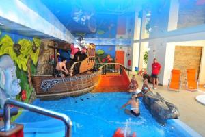 a group of people in a indoor water park at Arena Slonca in Łeba
