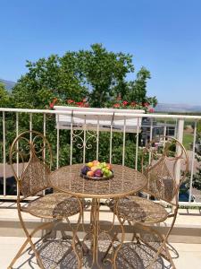 a table with a bowl of fruit on a balcony at The Roof in Kfar Blum