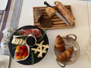 uma mesa com um prato de comida e uma bandeja de pão em L'ESCALE DE BEL AIR Chambres d'hôtes em Gauriac