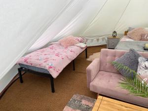 a room with a tent with a dog sleeping on a bed at River View Glamping in Llandovery +32 photos