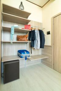 a walk in closet with wooden shelves and a blue suitcase at Hotel Valentino Centro Storico in Orvieto +101 photos