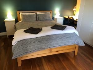 a bedroom with a bed with two towels on it at Clare to Spalding character escape in Spalding