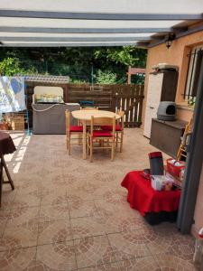 a patio with a table and chairs on a floor at La Toscane in Roquebrune-sur-Argens