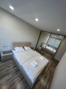 a bedroom with a large bed and a large window at A place to take a rest. in Tukums