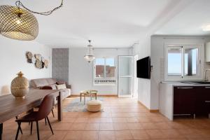 a living room with a dining room table and a kitchen at Luxury Ocean View - Carpe Mundi in Corralejo