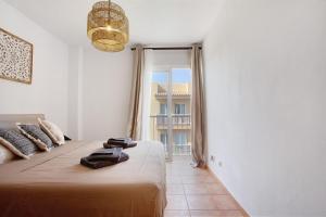 a bedroom with a bed and a large window at Luxury Ocean View - Carpe Mundi in Corralejo