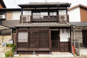 a small house with a balcony and a door at 游月庵 in Inuyama