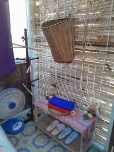 a bird cage with two teddy bears sitting on a bench at Pikban in Chiang Rai