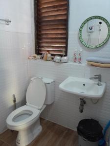 a bathroom with a toilet and a sink at Pikban in Chiang Rai
