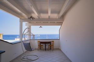 a view from the balcony of a house with a table and chairs at Casa Lussu in Lipari
