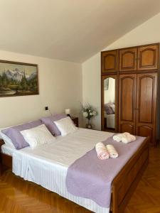 a bedroom with a large bed with two towels on it at Apartmani Mužić in Orlec