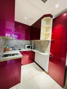 a kitchen with red cabinets and a sink at Apartments by GR Yerevan in the city centre in Yerevan