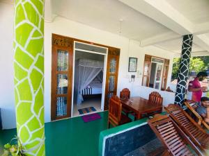 a room with a table and chairs and a dining room at Welcome Homestay in Ella