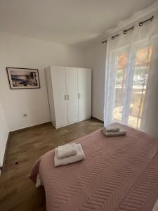 Postel nebo postele na pokoji v ubytování Apartments and Rooms Markovski
