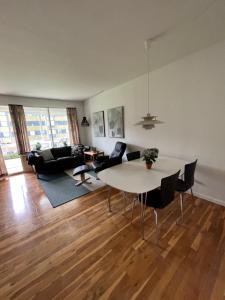 a living room with a table and chairs at Skelvangsvej in Randers