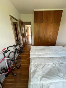 a bedroom with a bed and a bike parked next to it at Skelvangsvej in Randers