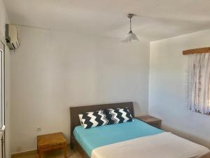 a small bedroom with a bed and a window at İncebel in Dalaman