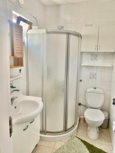 a bathroom with a shower and a toilet and a sink at İncebel in Dalaman