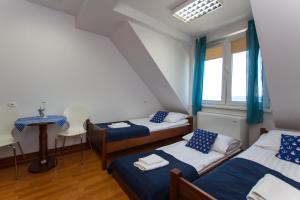 a room with two beds and a window at DALBA pokoje przy samej plaży in Krynica Morska