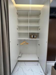 Levent beach 1,Luxury apartment في سومقاييت: خزانة بيضاء مع رفوف بيضاء