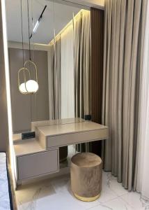 a dressing table with a stool and a mirror at Levent beach 1,Luxury apartment in Sumqayıt